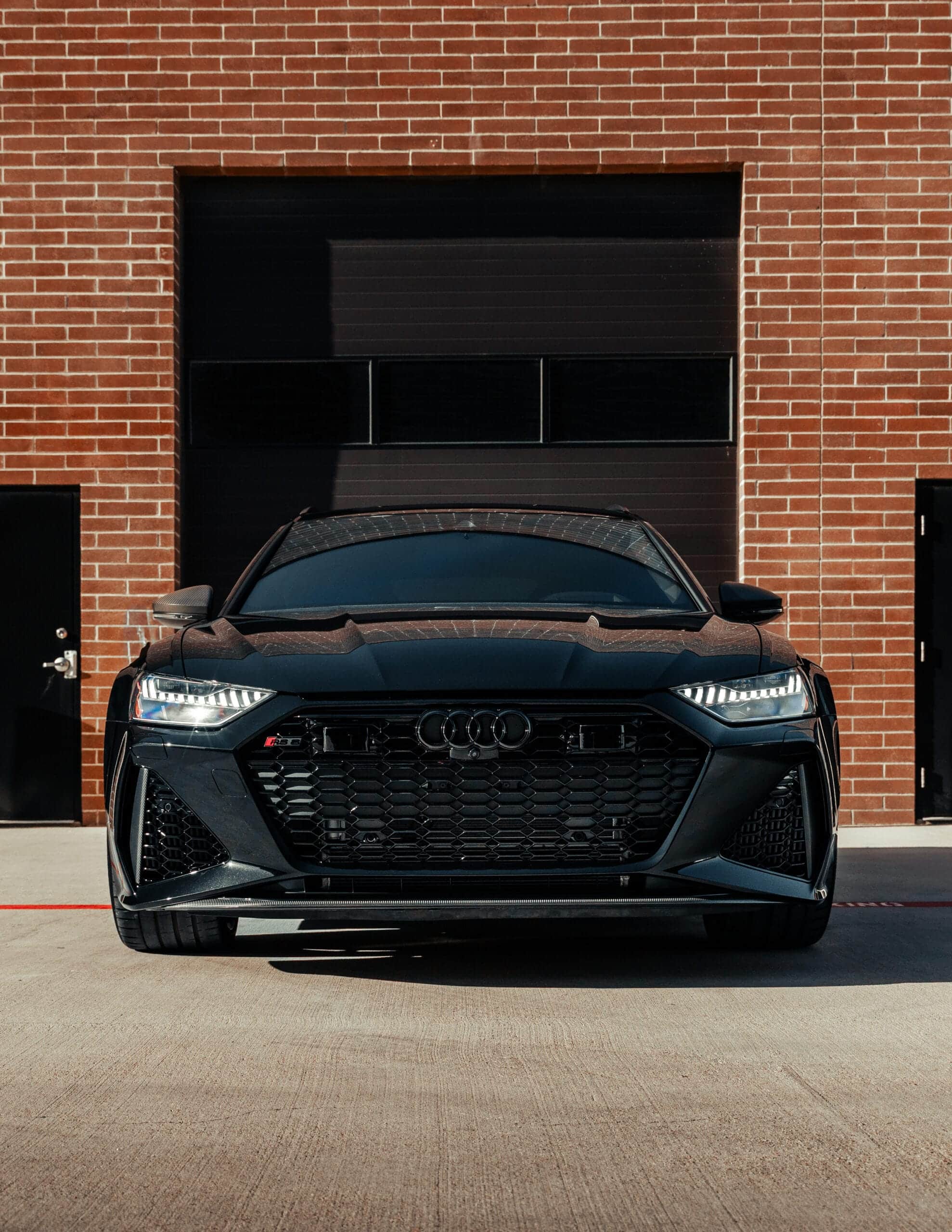 Front VIew of a black audi outdoors in Trophy Club. Installed is Paint protection film trophy club specific selected package.
